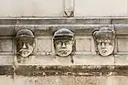 Heads on the exterior depict unknown individuals