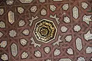 Close-up of the geometric designs and the added gilded motifs of the ceiling