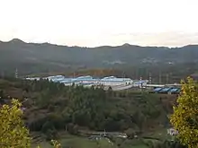 Prison buildings seen from above set in woodland