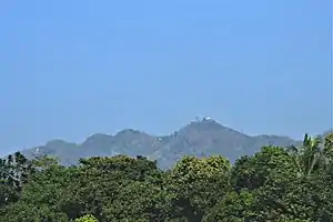 Chandranath Hill, as seen from the Dhaka-Chittagong railroad. It is the tallest peak in Chittagong district, and is the location of Chandranath and Birupakkha temples.