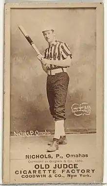 Standing man in baseball uniform with bat