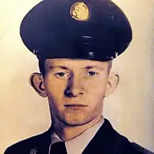 A portrait photo of a white man in a Cold-War US military uniform; he is facing the camera, looking into the lens