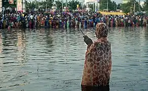 A woman praying during Chhath