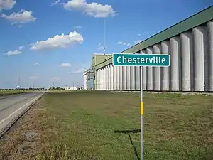 Sign on FM 1093 with grain elevator as backdrop