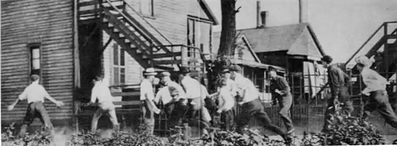 A white gang looking for African Americans during the Chicago Race Riot of 1919. This and a subsequent  picture at The Crisis Magazine 1919 Vol 18 No. 6 is part of a series of the Chicago race riots of 1919.The first  pictures of the white gang chasing a victim are at  and