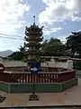 A small pagoda located at the temple with a Chinese architectural and style.