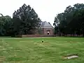 Christ Church with graveyard and restored brick wall in foreground