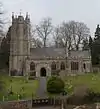 Stone building with square tower.