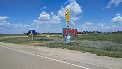 Welcome sign at the entrance to the selo of Chyorny Yar, the administrative center of Chernoyarsky District