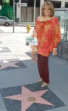 Robinson next to the Hollywood Walk of Fame star for The Miracles in 2013