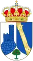 A shield with a crown on top. The shield is divided in three parts, having the left part an image of the watchtower of Torrelodones, colored blue with a white background, the right side has two dragon looking yellow creatures facing each other over a blue background, and on the bottom part is a small green three with red fruits over a white background