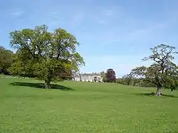 Parkland with a mansion in the distance