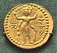 Three-faced four-armed Oesho with attributes, often identified with Shiva, on a coin of Huvishka.