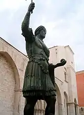 The statue from the right