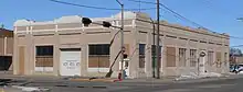 One-story building on street corner with garage entrances on south and east sides