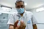 A vial of the first component of the Sputnik V vaccine in the hands of an Argentine paramedic