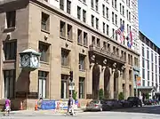 Street level entrance, with landmark clock and porte-cochère entry on the far right.