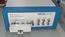 Computer controlled impedance analyzer based on the direct I-V mode with test fixture attached.