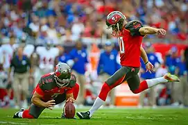 A placekicker attempts a field goal by kicking the ball from the hands of a holder.