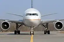 Twin-engine airliner with landing gear and flaps extended