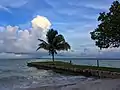 A storm looms off the Corozal coastline opposite the setting sun