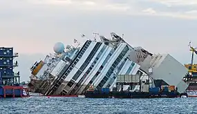 The operation progesses slowly, at less than 2 degrees per hour. On the right are the port side sponsons.