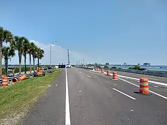 Highway diverted from former alignment to pass around construction site with crane