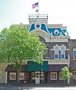 Three story building with an elaborate roof, including a widow's walk