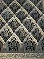 Sebka motif filled with arabesques in the carved stucco decoration of the Cuarto Real de Santo Domingo in Granada, Spain