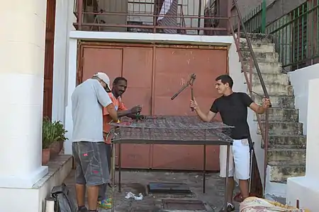 Repairing an all-metal boxspring in Cuba