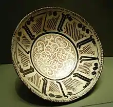 Bowl with Kufic Inscriptions found in the archeological excavations of Nishapur. The Middle East Institute's logo has been inspired by this bowl. This bowl is currently held in the Met.