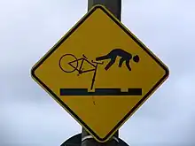 Cyclist falling over their front wheel stuck in groove