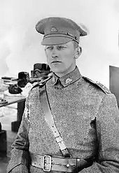 Half portrait of young man in military uniform with peaked cap