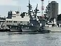 JS Yūdachi alongside JS Fuyuzuki and JS Hyūga at Yokosuka on 25 September 2017.