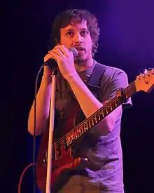 man playing a guitar onstage