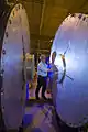 A technician examining one of the refurbished accelerator cells for DARHT's second-axis accelerator.