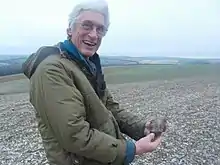 Bangs having just found a Neolithic axe head on the Brighton Downs, January 2021.