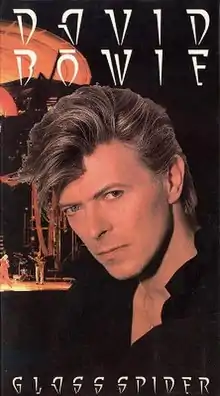 A picture showing a contemporary portrait of David Bowie in front of a shot of the Glass Spider Tour's stage