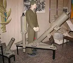 Batei HaOsef Museum exhibit of a Davidka mortar with a cutaway shell to the left of the mannequin