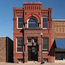 A two-story building made of red masonry.