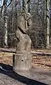 Wooden Neanderthaler sculpture by Ad Wouters in Heverleebos