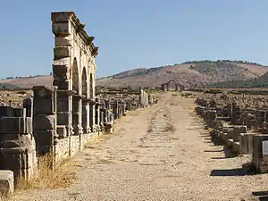 View up a wide street with a colonnade on the left side