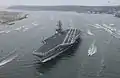 Sailors aboard Ronald Reagan man the rails as the supercarrier arrives at her new homeport in San Diego, California, on 23 July 2004.