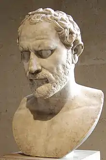 White stone sculpture of a bearded man's head