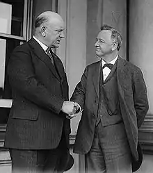 Denby shaking hands with his predecessor as Secretary of the Navy, Josephus Daniels