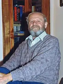 A portrait photograph of Leonid Denysenko at his home.