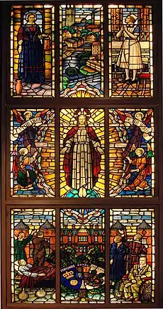 A vertical rectangular stained glass window with nine panels, each holding one or more human figures