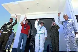 Sec. Delfin Lorenzana leads a toast of the water produced by the desalination plant at Mavulis Island.