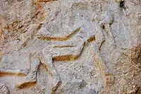 Detail, a dead or dying Lullubian warrior, Darband-i Gawr rock-relief, Mt. Qaradagh, Sulaymaniyah, Iraq, 2200-2000 BCE