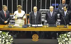 Dilma reads the oath of office, with President of the Chamber of Deputies Marco Maia at her right, and President of the Senate José Sarney, Vice President Michel Temer, and President of the Supreme Federal Court Cezar Peluso at her left.